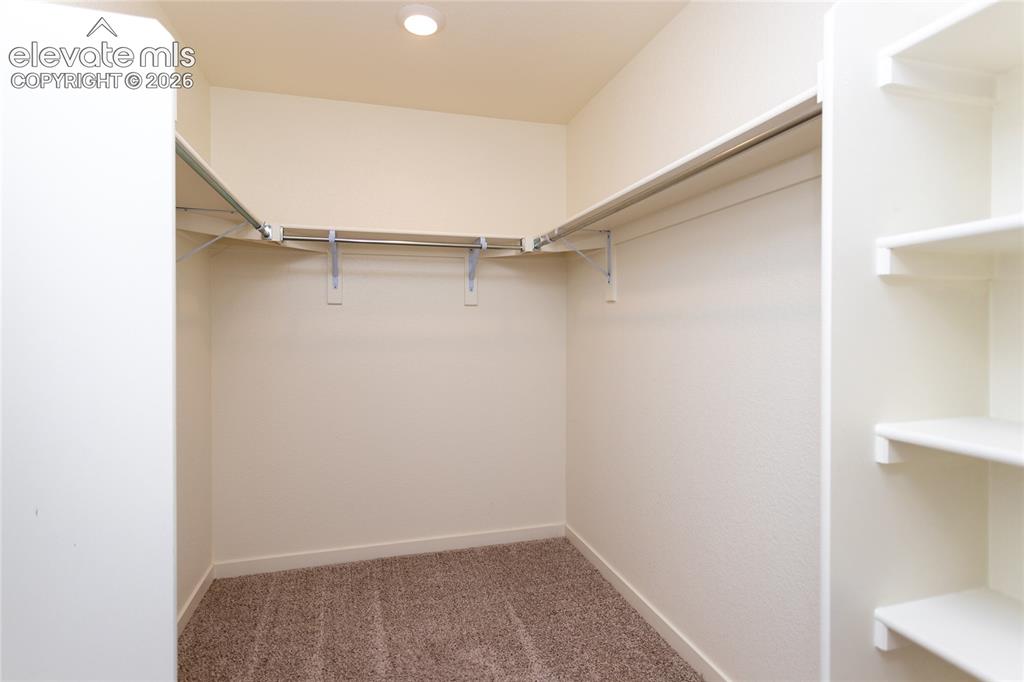 Image 26 of 48: Very roomy walk-in closet completes the primary suite.