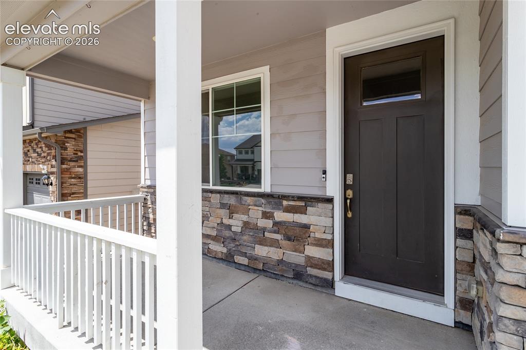 Image 3 of 48: Welcoming covered front porch.