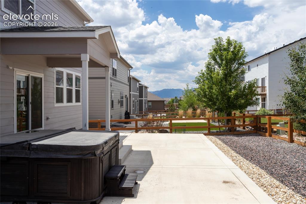 Image 39 of 48: Expanded, partially covered patio with mountain views is perfect for outdoo