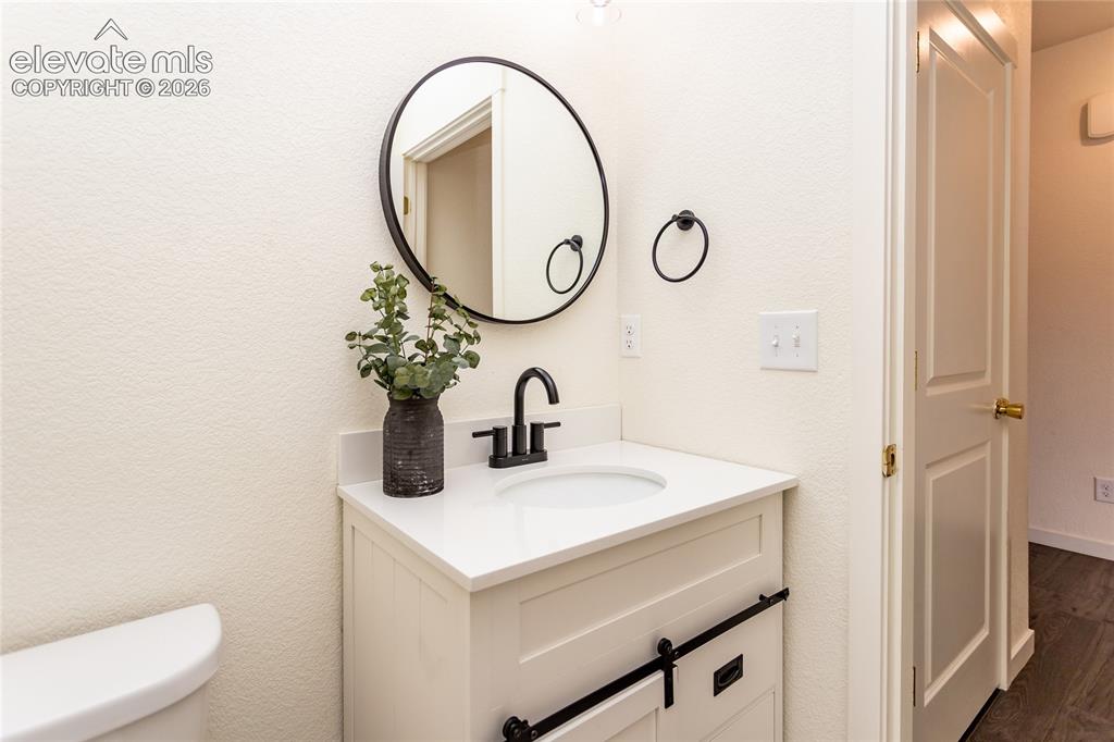 Image 7 of 48: Beautiful powder room and a coat closet are located near the entry.