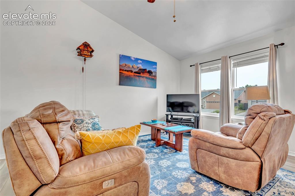 Image 11 of 28: Another view of the living room. The room can be bright with the blinds and