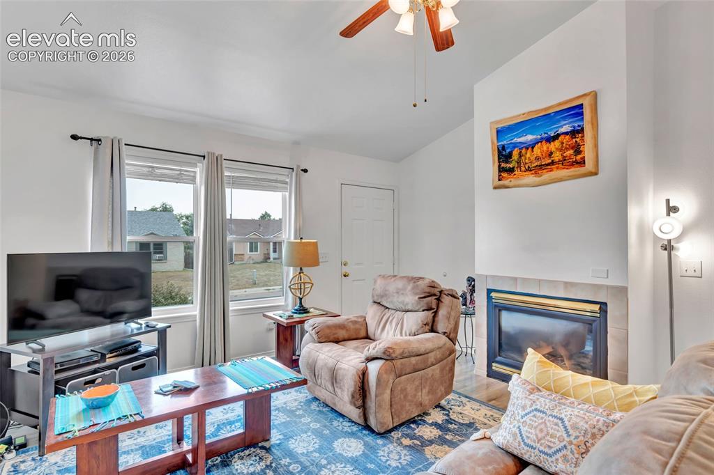 Image 12 of 28: Living room has a gas fireplace, ready to keep you toasty on those cool Col