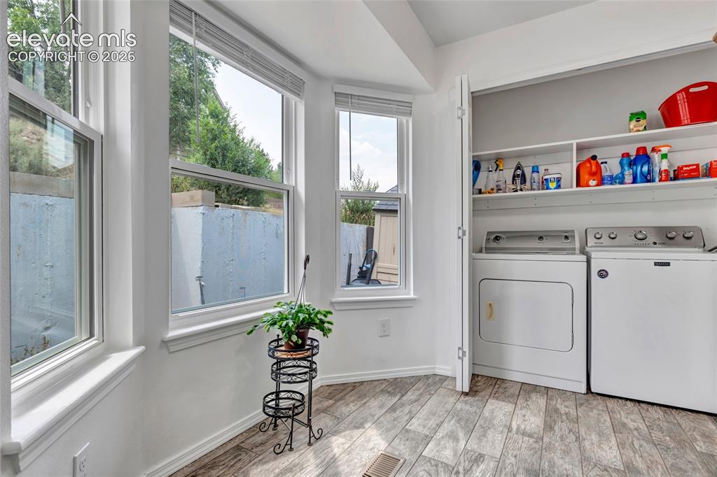 Image 15 of 28: The laundry facilities are in a closet at the end of the kitchen/ dining ro