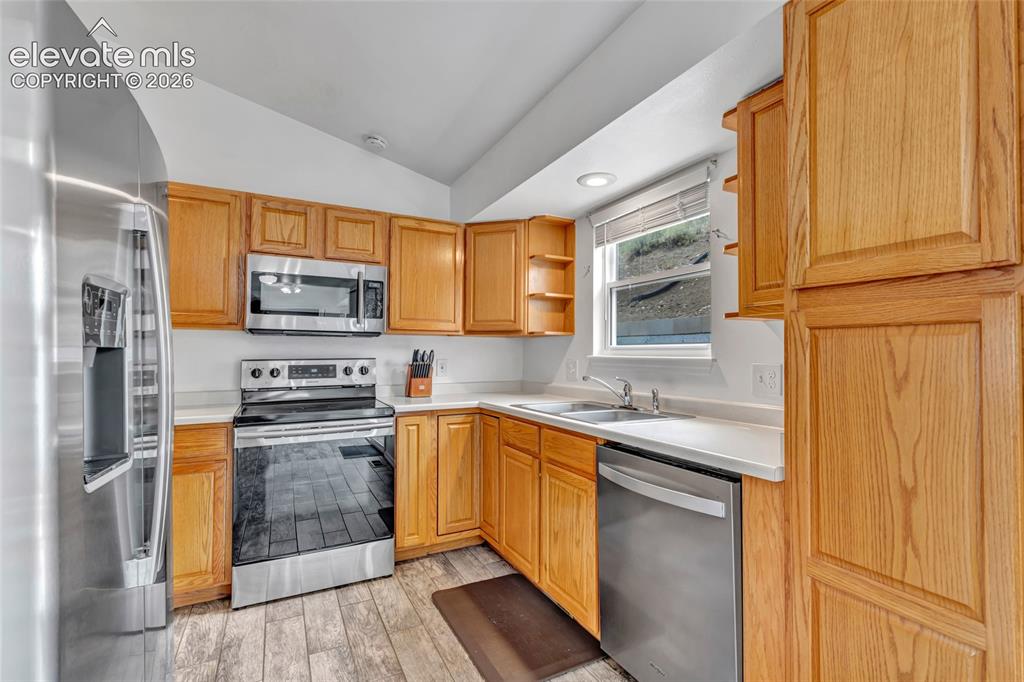 Image 16 of 28: The kitchen includes newer appliances and plenty of room to store all your