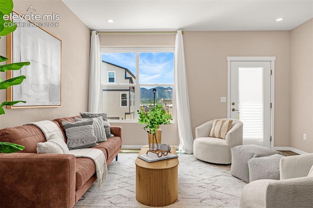 Image 13 of 28: Expansive window with mountain scenery, recessed lighting, and wood-finish
