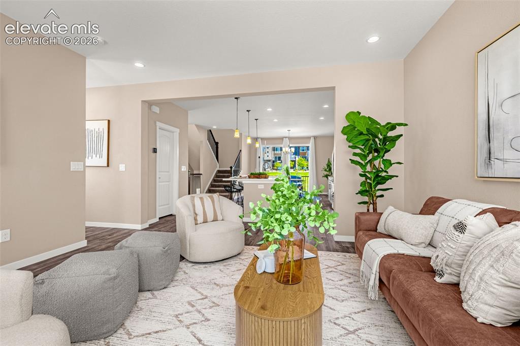 Image 14 of 28: Wood-finish flooring throughout, recessed lighting, and a neutral wall pale