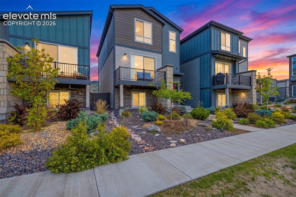 Image 2 of 28: Modern architecture with multiple balconies, stone facade accents, and matu