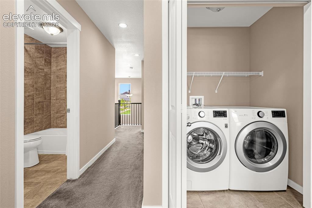 Image 24 of 28: Dedicated laundry closet with wire shelving