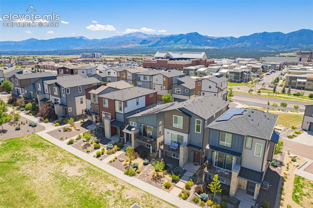 Image 28 of 28: Mountain scenery with an urban residential development featuring contempora