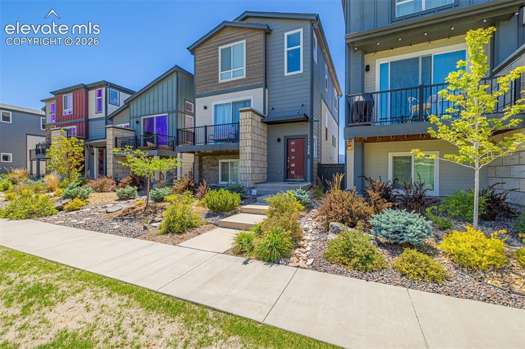 Image 29 of 32: Modern multifamily residence featuring a stone and siding exterior