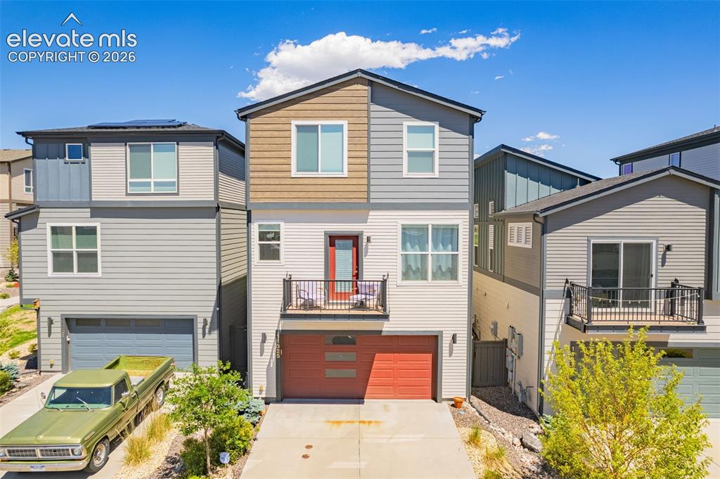 Image 4 of 28: Modern multi-story exterior with horizontal siding and accent panels