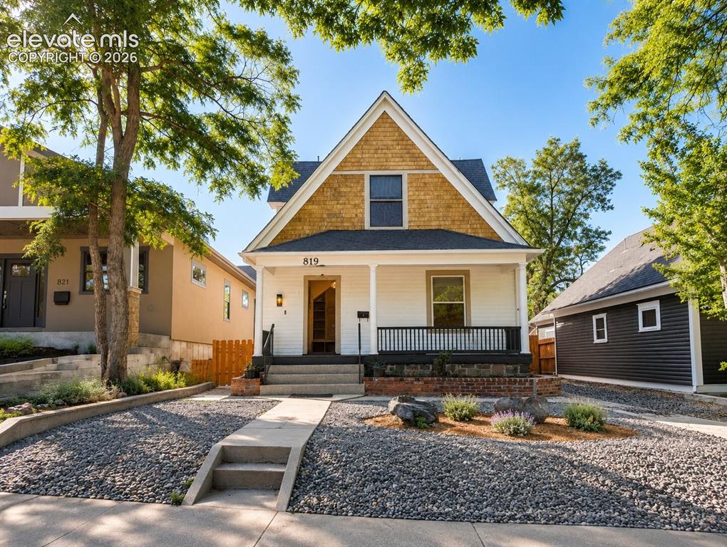 Caption: Gabled roofline with shake siding accent, white horizontal siding, covered porch with white columns 