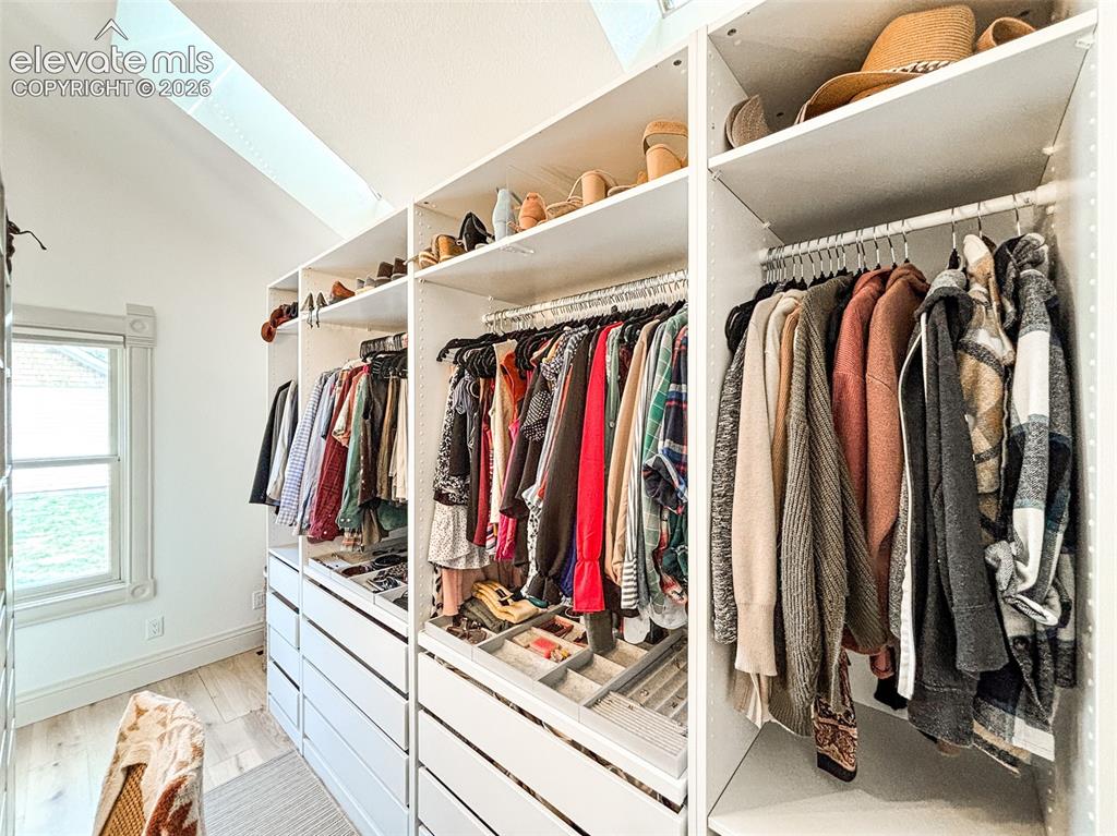 Image 17 of 33: Custom closet organization system featuring multiple shelving units and int