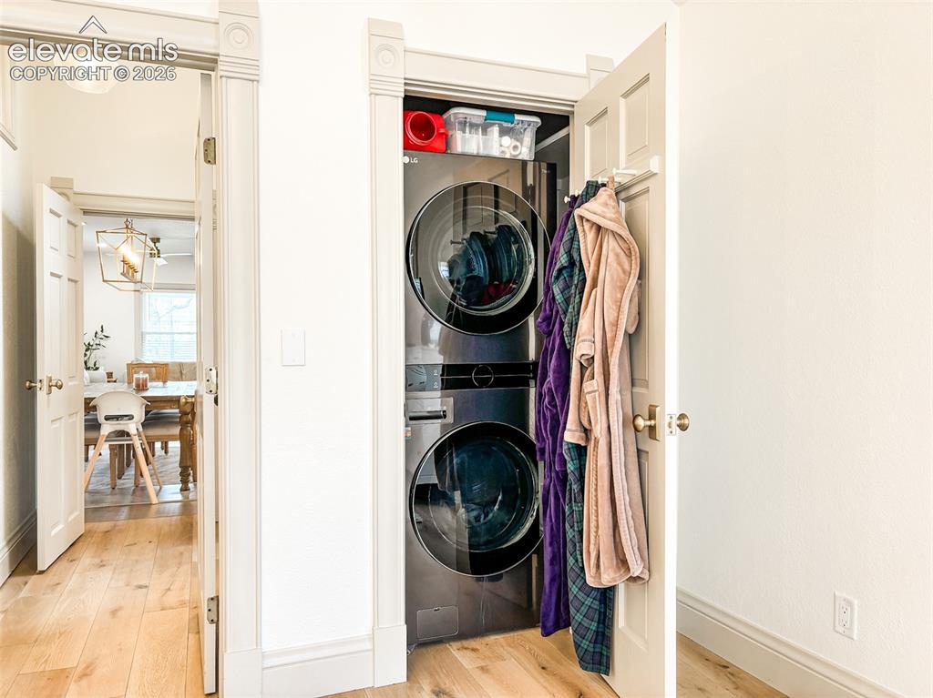 Image 19 of 33: Integrated laundry closet featuring stacked washer and dryer units