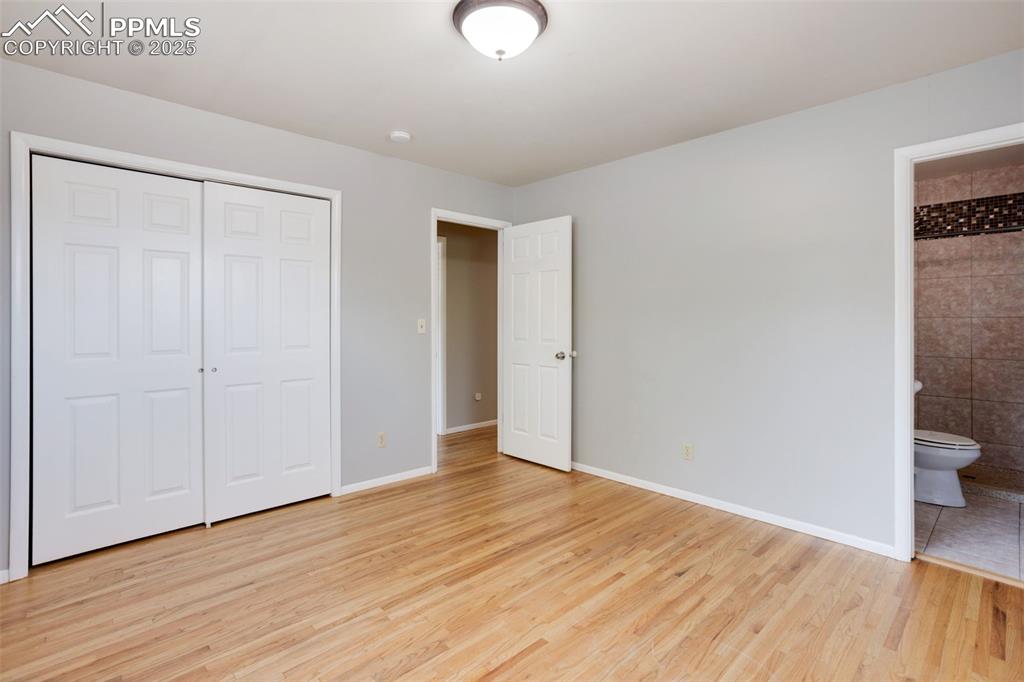 Image 12 of 35: Unfurnished bedroom featuring light wood-type flooring, a closet, and conne