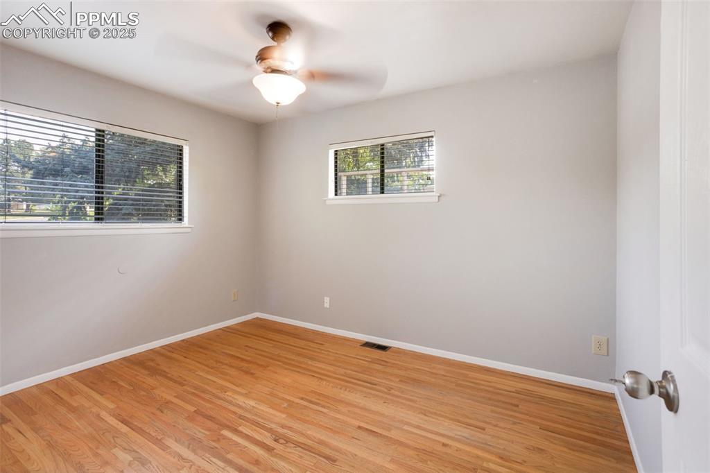 Image 13 of 35: Unfurnished room with light wood-style floors and ceiling fan