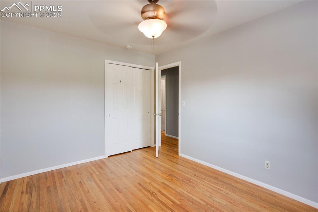 Image 14 of 35: Unfurnished bedroom featuring light wood-style flooring, a closet, and a ce