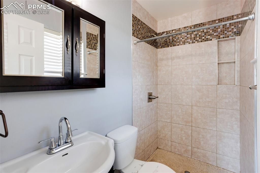 Image 21 of 35: Full bathroom featuring a stall shower and toilet