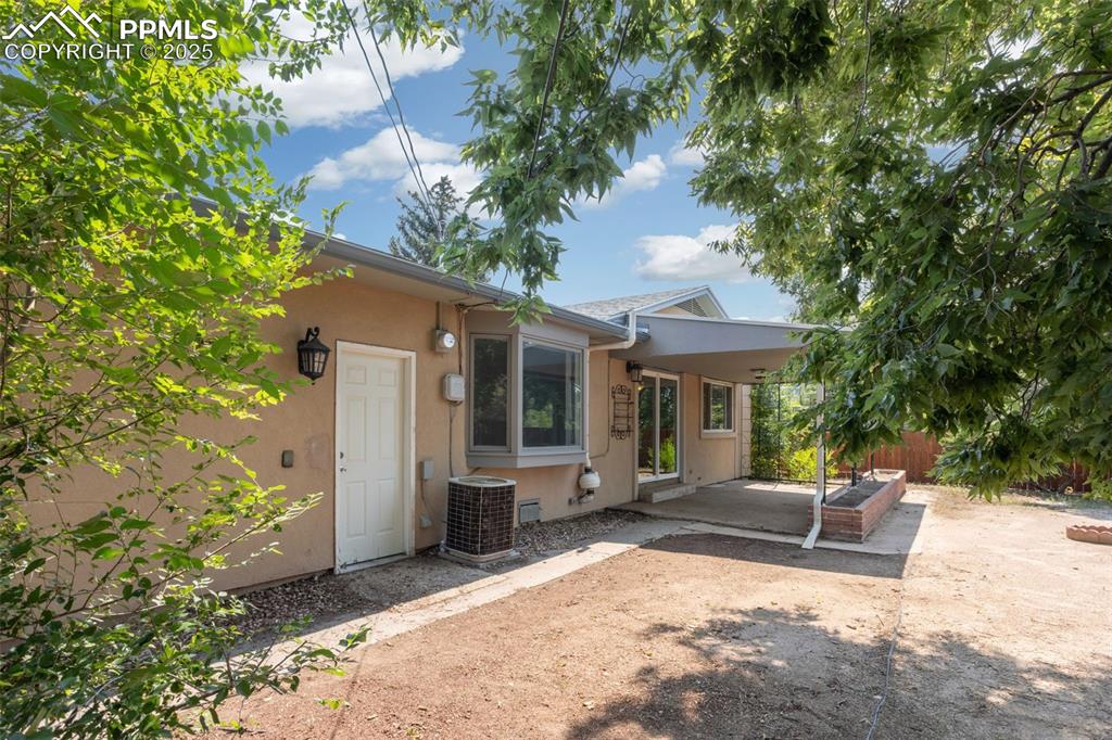 Image 24 of 35: Back of house featuring stucco siding