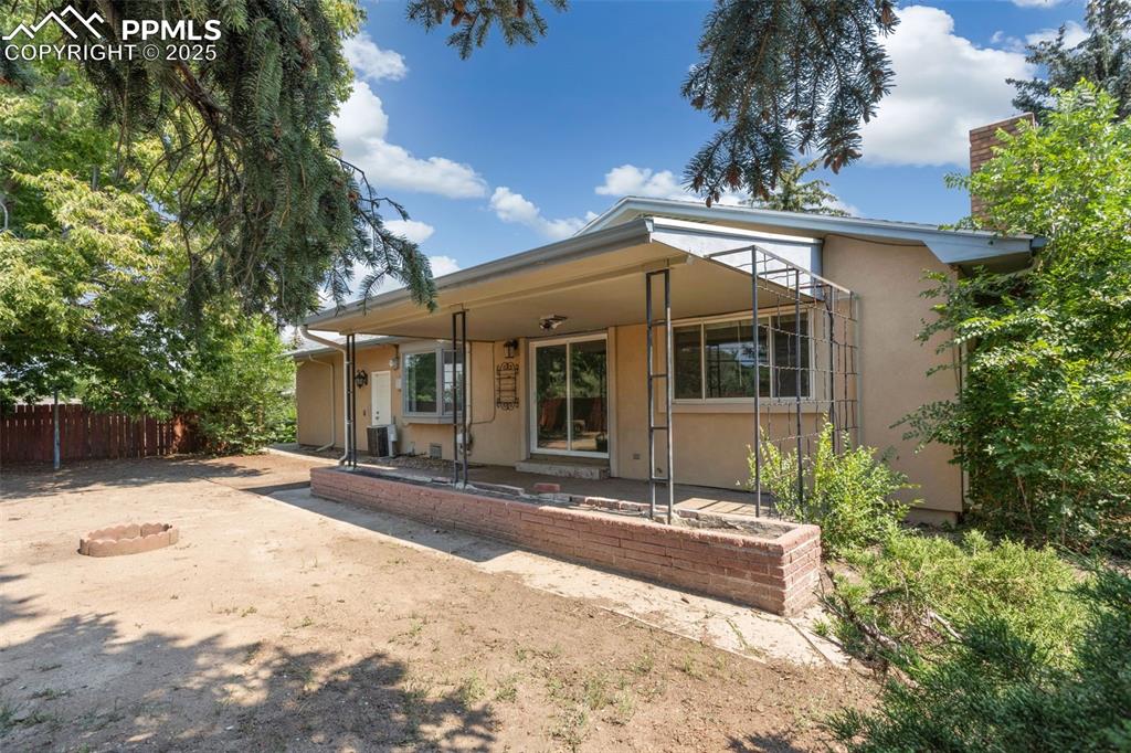 Image 25 of 35: Rear view of house featuring a patio area and stucco siding