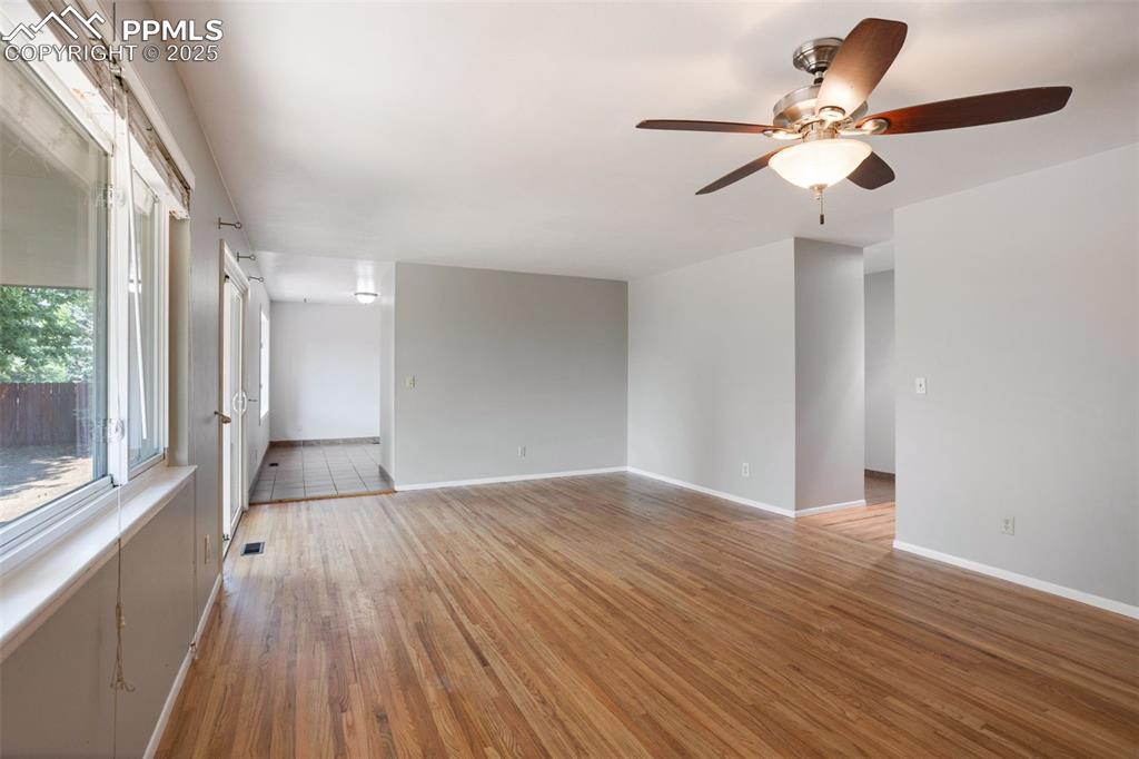 Image 6 of 35: Spare room with light wood-type flooring and a ceiling fan