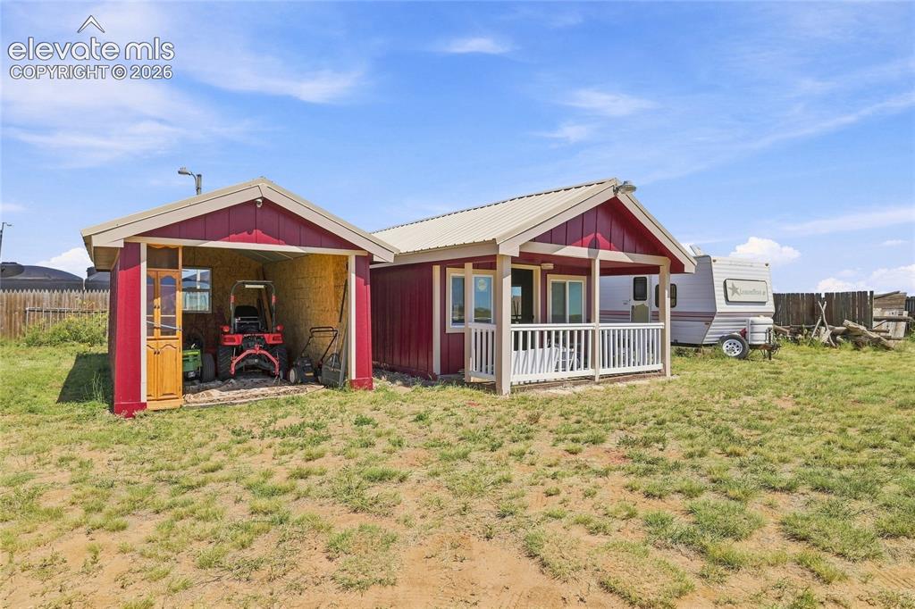 Image 20 of 29: Kids playhouse and storage/parking