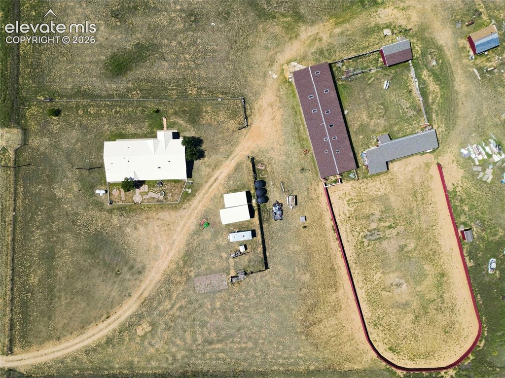 Image 28 of 29: Home, Stable, Horse Arena/Stable and out buildings pictured.