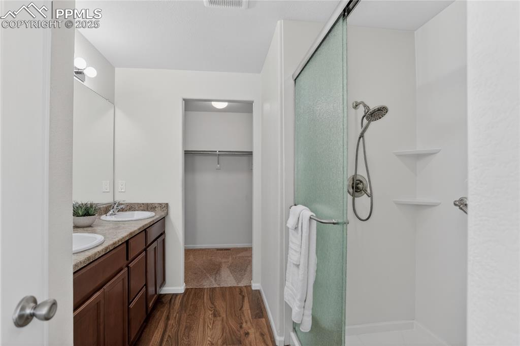 Image 11 of 20: Primary bath w/ dual sink vanity