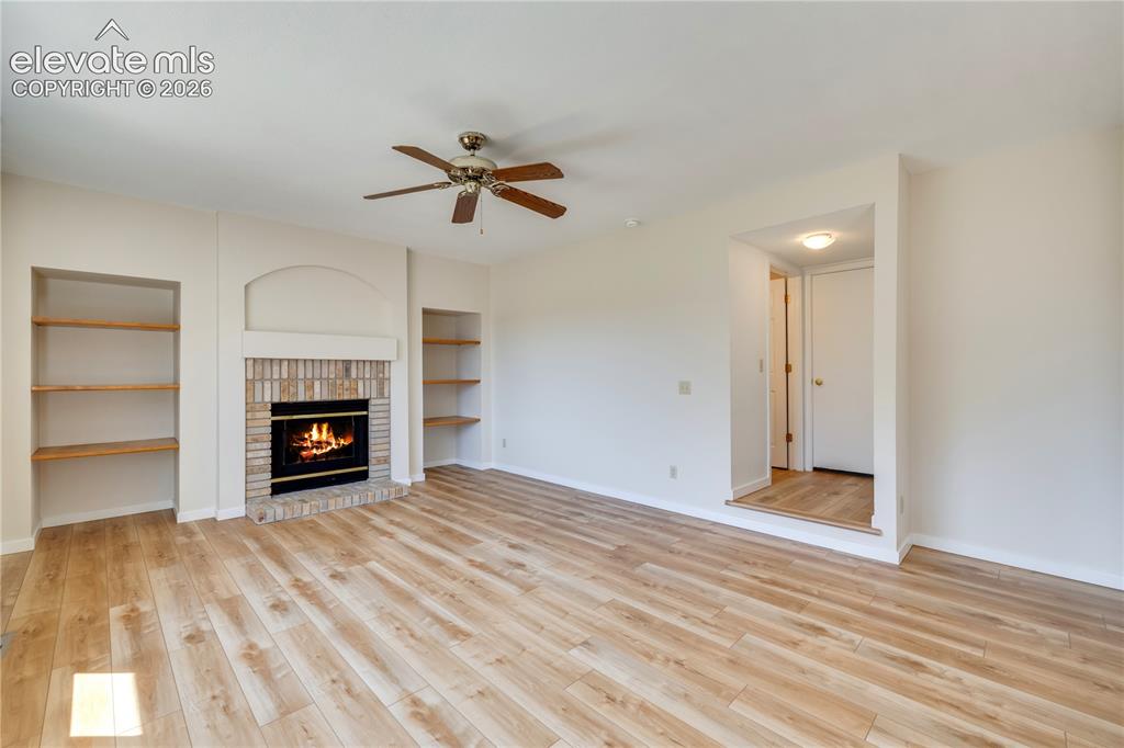 Image 13 of 47: Family room has built-ins and shelves