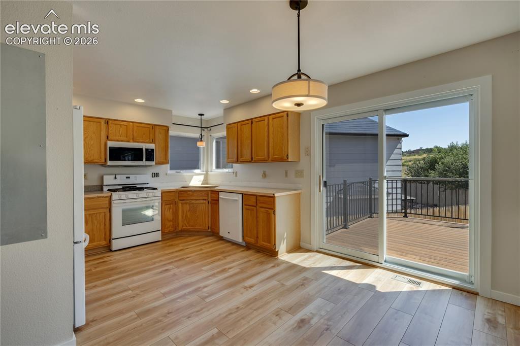Image 16 of 47: New luxury vinyl plank flooring in kitchen