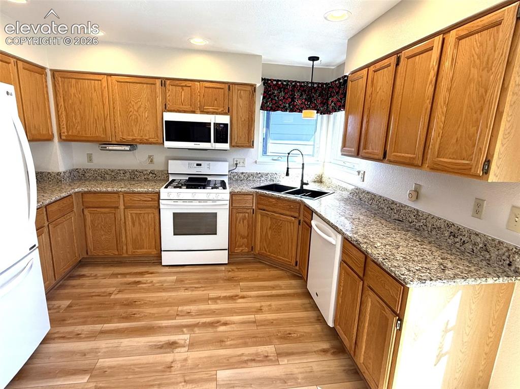 Image 18 of 47: New luxury vinyl plank flooring in kitchen