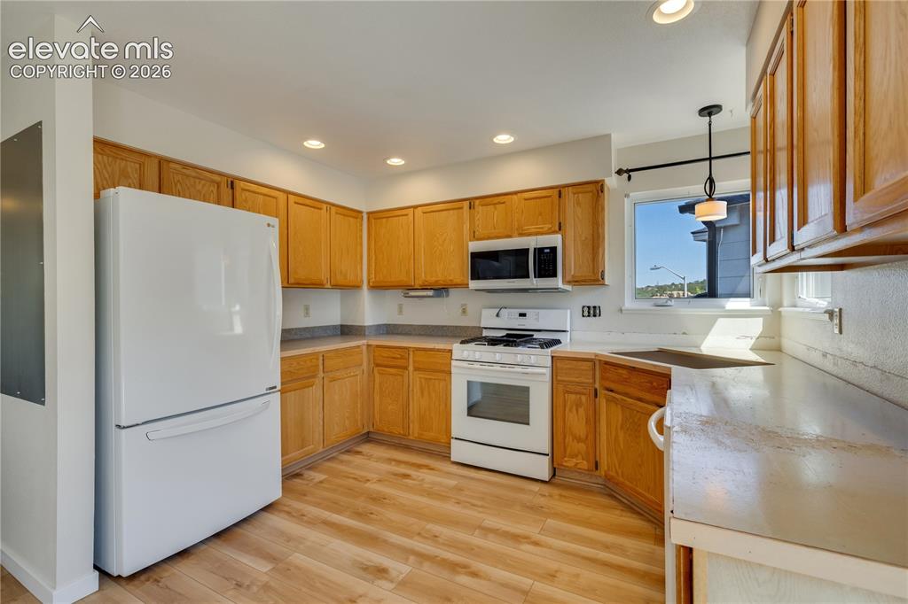 Image 21 of 47: Newer kitchen appliances and new luxury vinyl plank flooring in kitchen