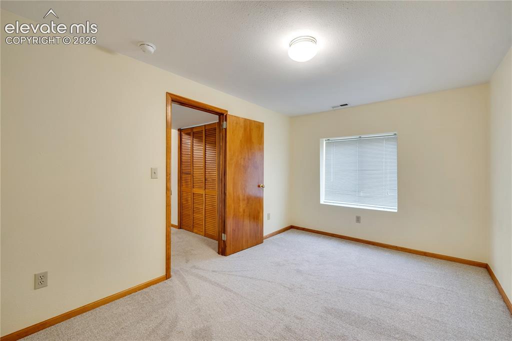 Image 37 of 47: Bonus room/craft room/study in basement, could be bedroom #5 but no closet
