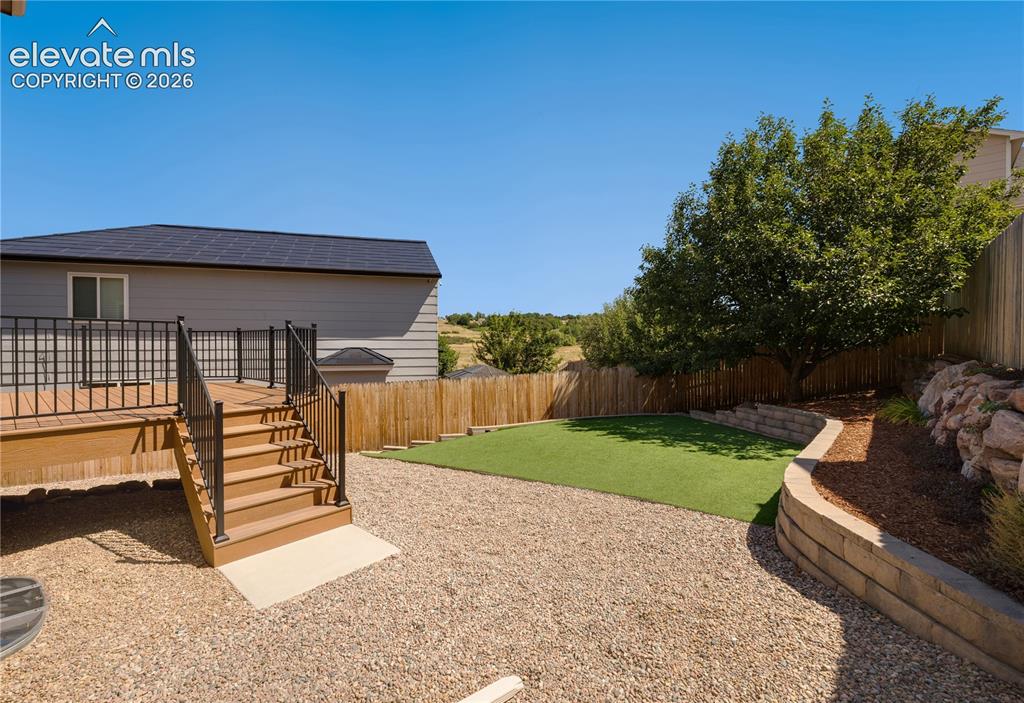Image 42 of 47: Backyard has new 12 x 14 composite deck, artificial turf, and landscaping a