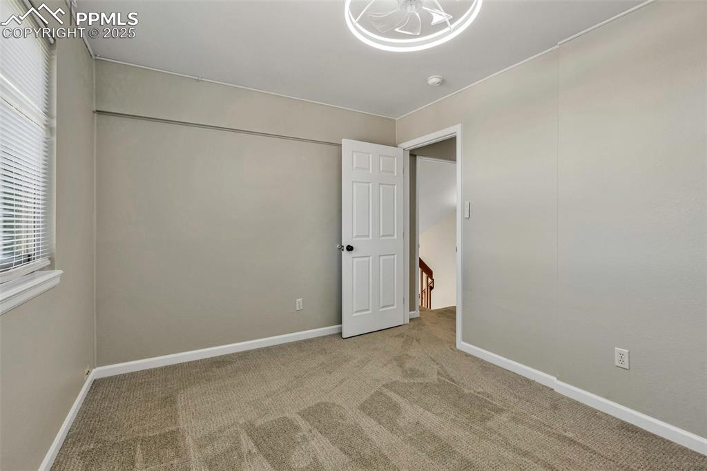 Image 31 of 47: Spare room with carpet floors and baseboards
