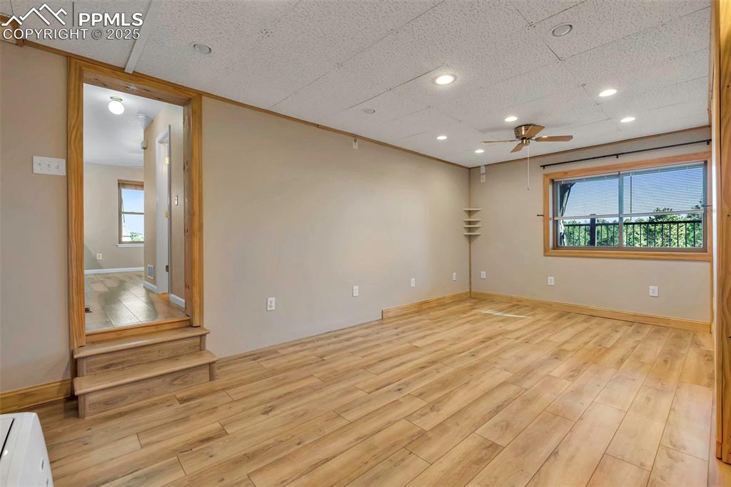 Image 36 of 47: Unfurnished room featuring light wood-style floors, ceiling fan, a textured