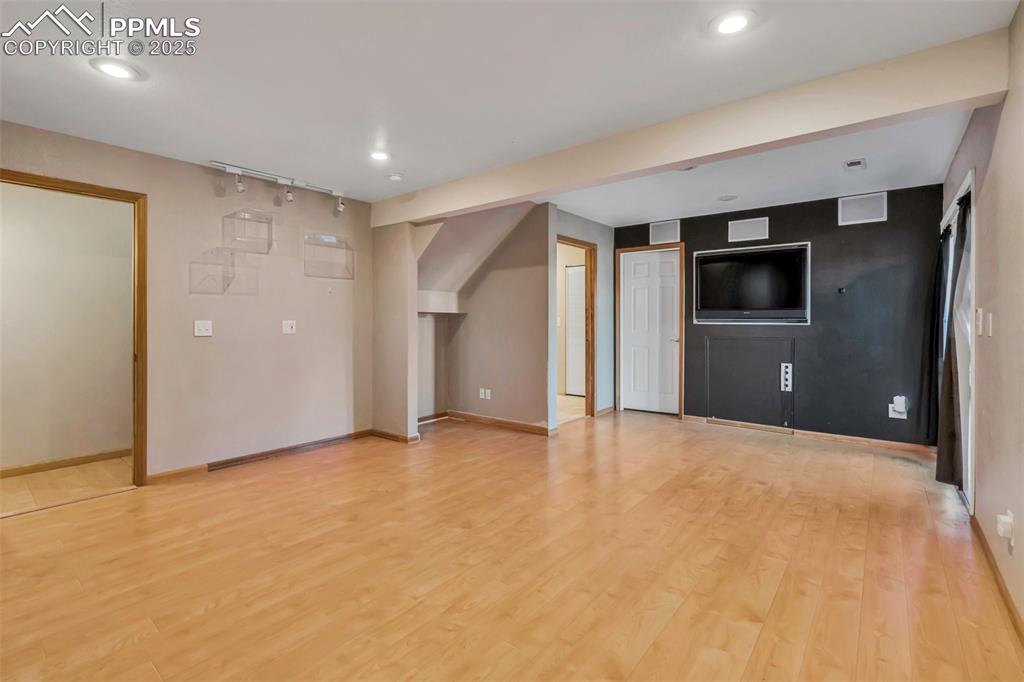 Image 40 of 47: Unfurnished living room with light wood-style flooring and recessed lightin