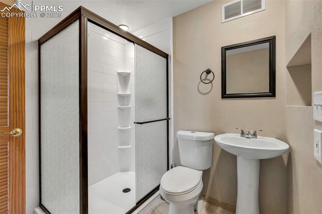Image 41 of 47: Remodeled basement bathroom.