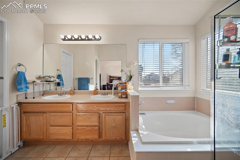 Image 23 of 48: 5 piece primary bathroom with a large walk-in closet