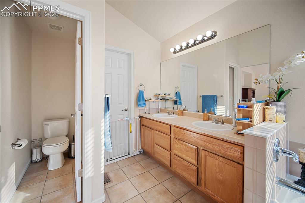 Image 24 of 48: 5 piece primary bathroom with a large walk-in closet