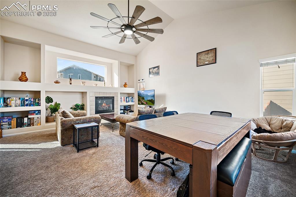 Image 6 of 48: Enter into the living room with vaulted ceilings, a gas fireplace, and load