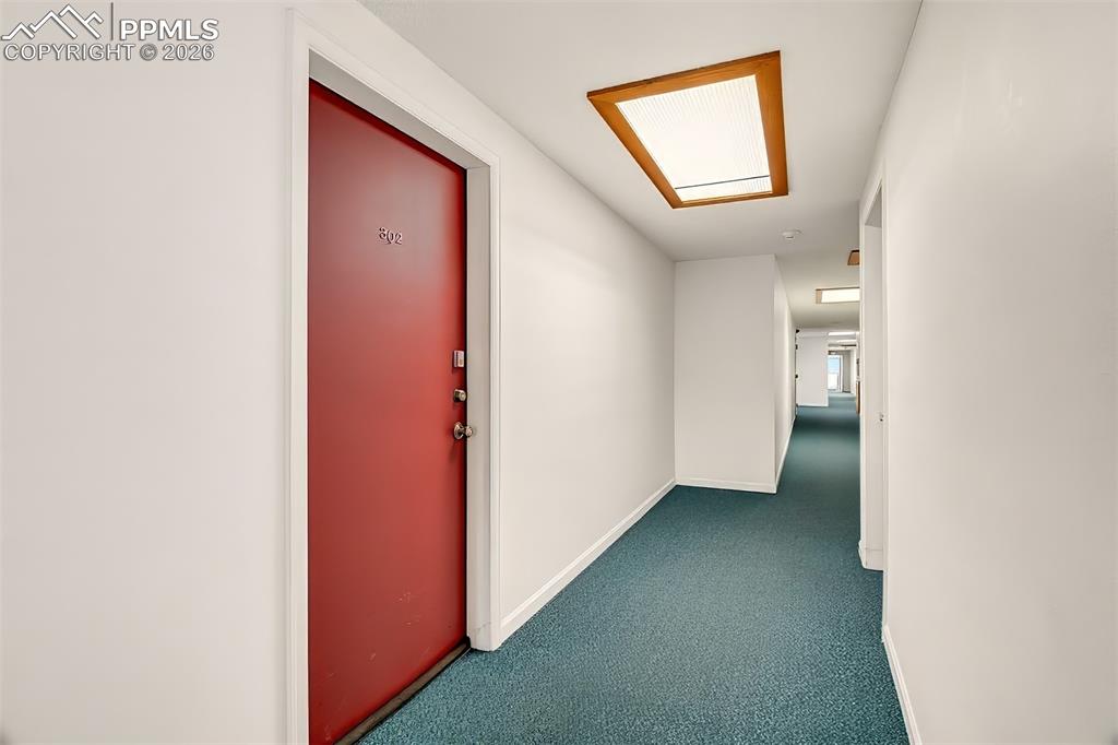 Image 21 of 36: Hallway to Unit