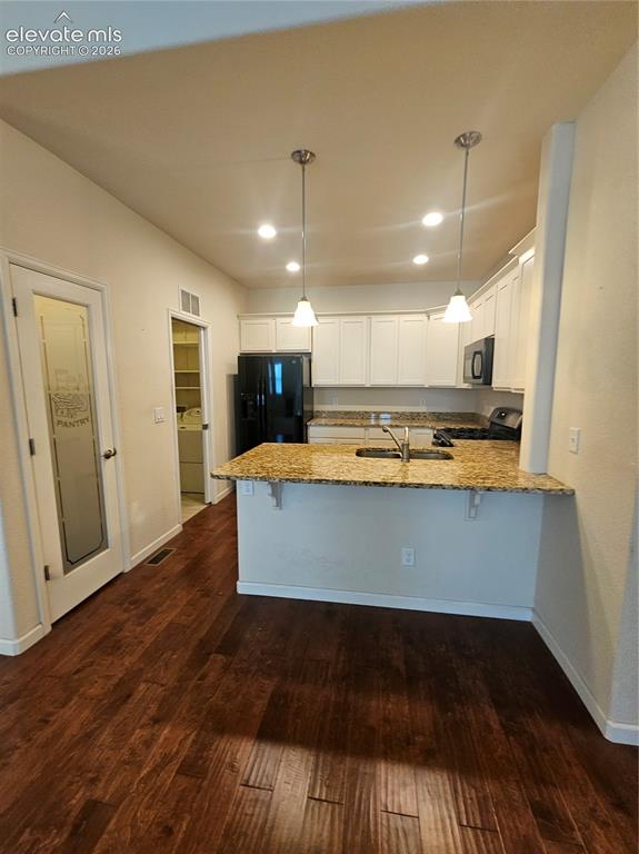 Image 7 of 32: Kitchen with island, cabinet storage, and built-in appliances.