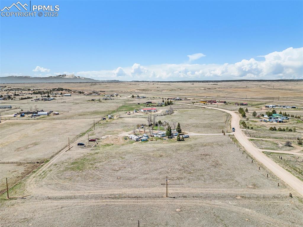 Image 23 of 25: Drone / aerial view with view of desert, a mountain view, and a rural view