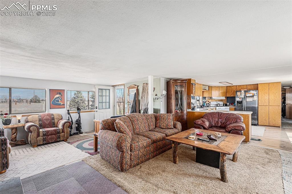 Image 5 of 25: Living area featuring a textured ceiling