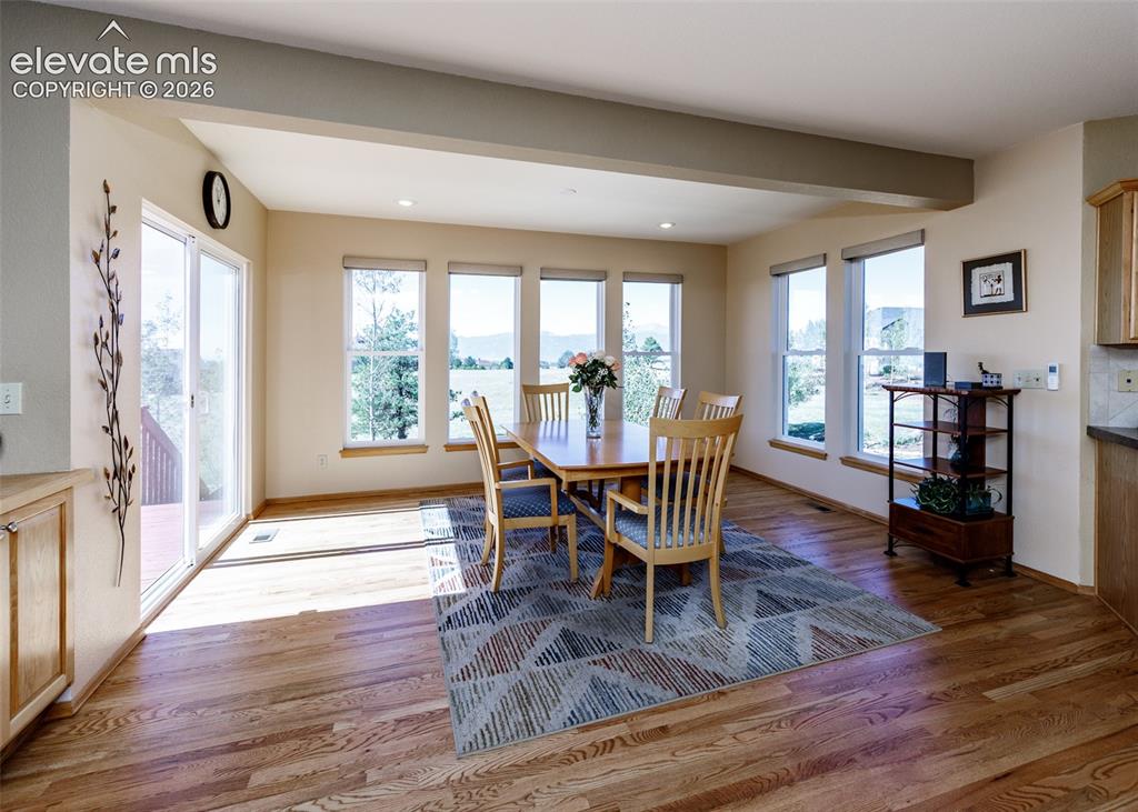 Image 19 of 48: Hardwood flooring, expansive windows, recessed lighting, and a sliding glas