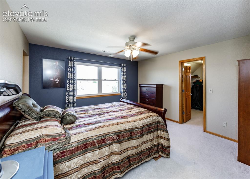 Image 37 of 48: Recessed window with wood trim, ceiling fan light fixture, light-colored ca