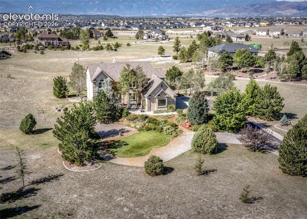 Image 43 of 48: Expansive property featuring a stone and stucco exterior, multiple gables,