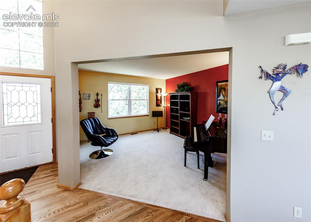 Image 8 of 48: Entryway featuring wood-finish flooring, a decorative glass-paneled door, a