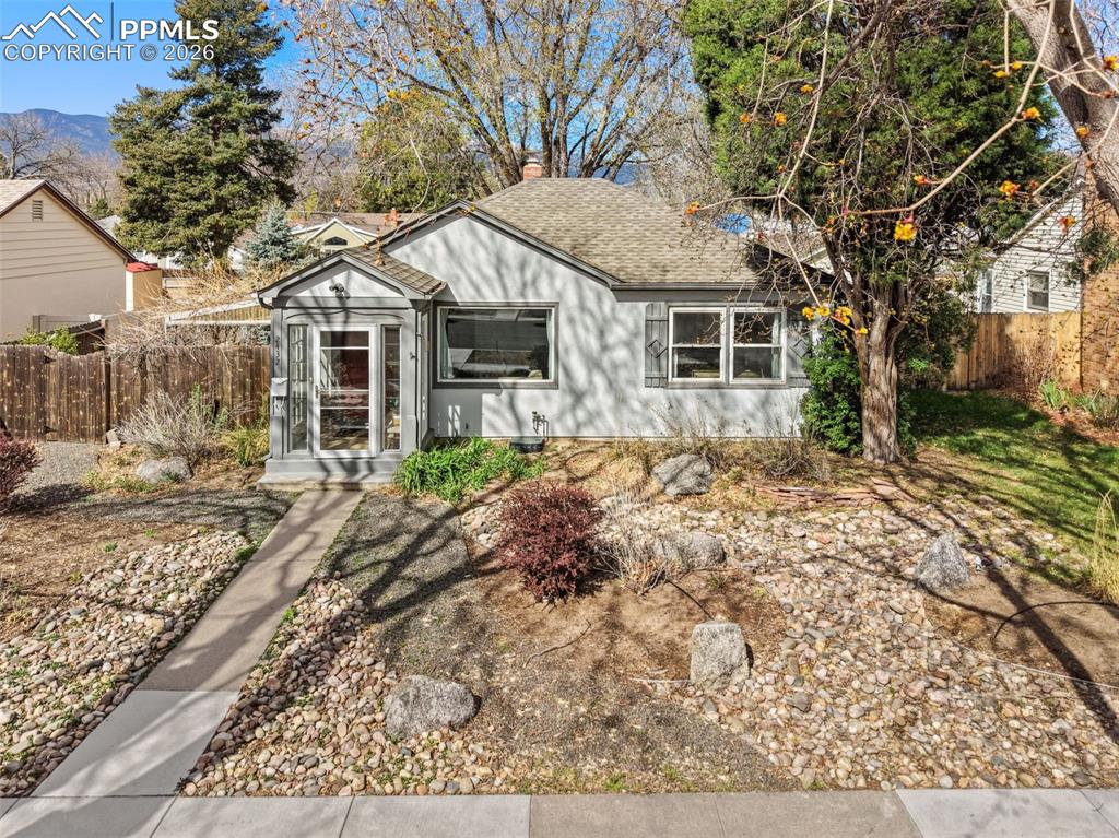 Image 1 of 28: View of front of house featuring a chimney and a shingled roof